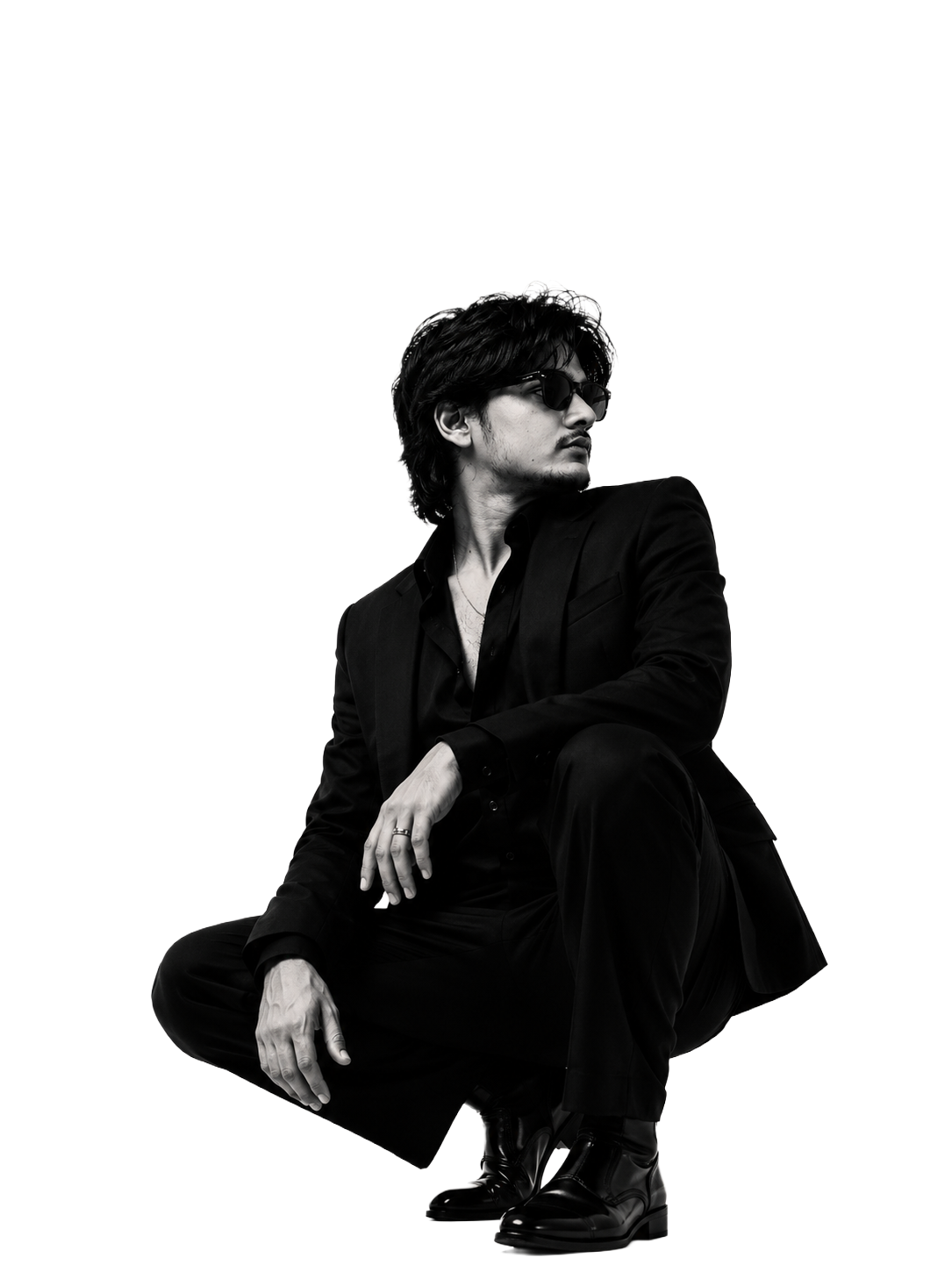 Black and white portrait of a crouching man